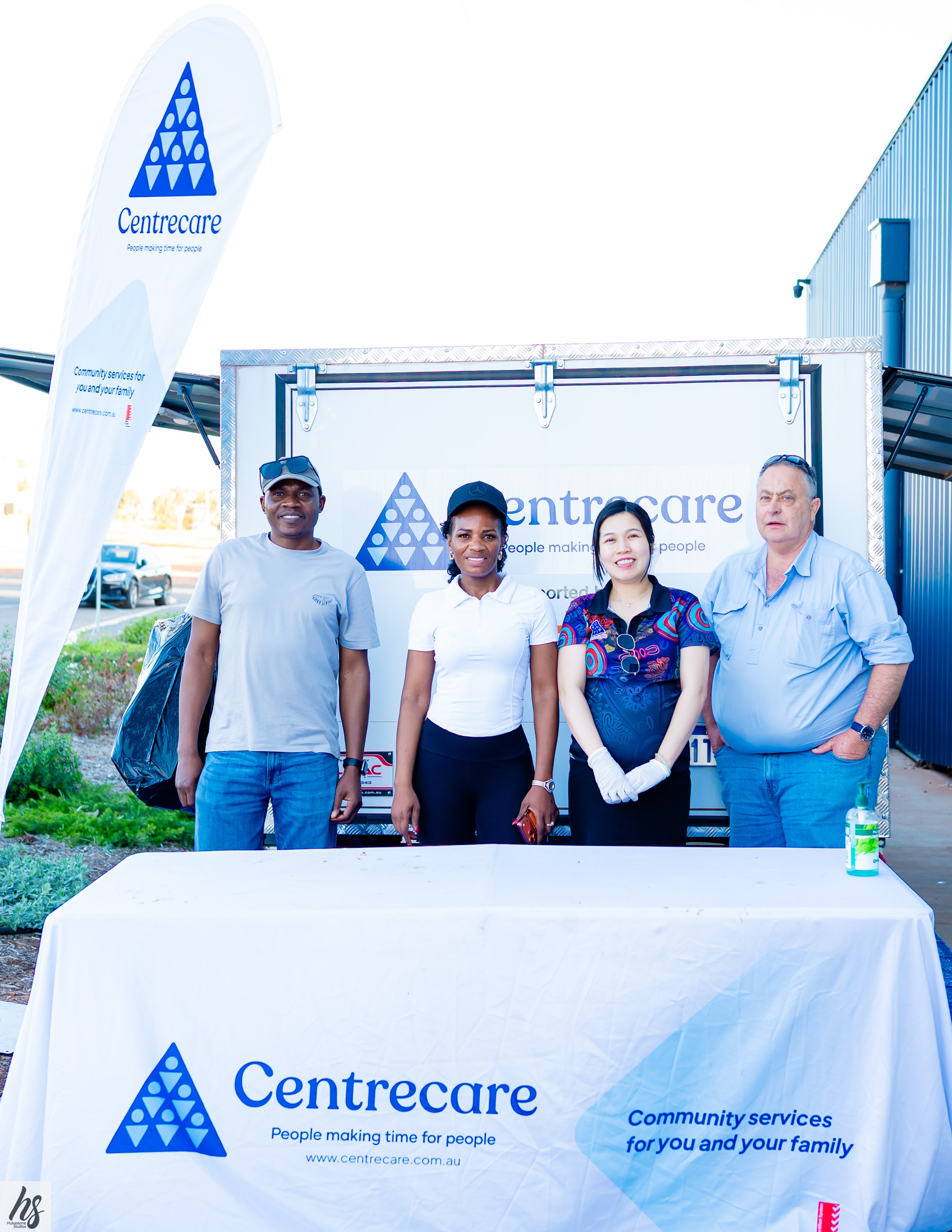 Corporate team photo at a branded event backdrop
