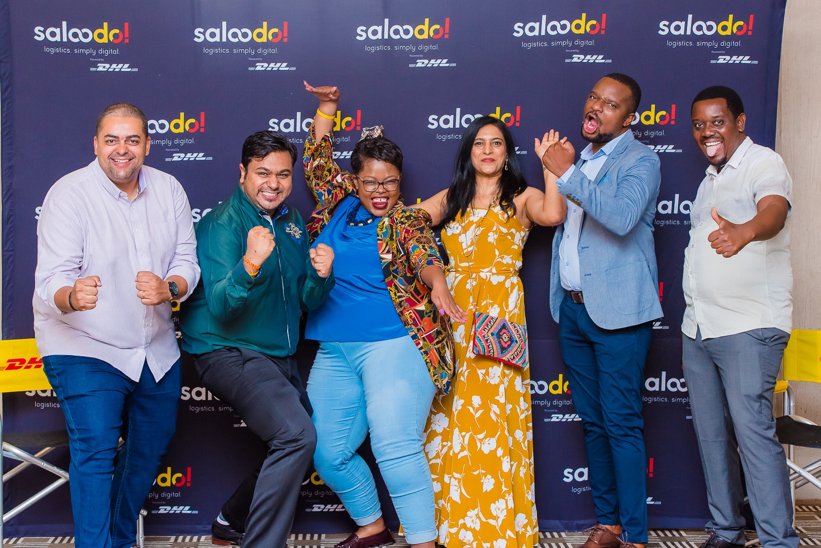 Group photo at a branded corporate event backdrop
