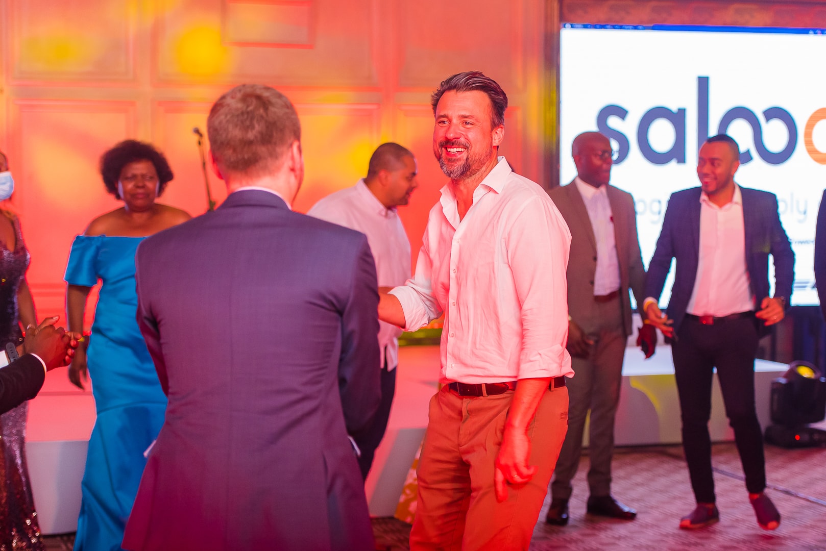 Guests gathered at a warm-lit corporate event